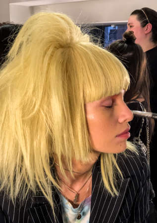 NEW YORK, NEW YORK - SEPTEMBER 06: A model getting ready backstage for the Jeremy Scott runway show during NYFW at Spring Studios on September 06, 2019 in NYCのeditorial素材