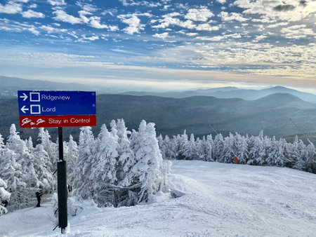 Beautiful snow day at the Stowe Mountain Ski resort Vermont, blue trails sign - December 2020のeditorial素材