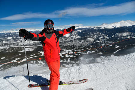 Man in red ski suit standing on the top of Breckenridge ski resort. Extreme winter sports. Breckenridge , COの写真素材