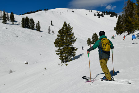 Vail ski resort in winter time with snow in the Colorado Rocky Mountains - Skier looking over the...