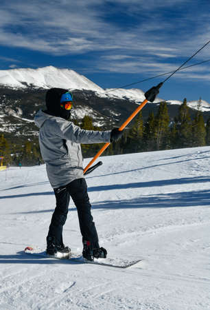 People using t-bar ski lift to get on the top of Breckenridge, Colorado