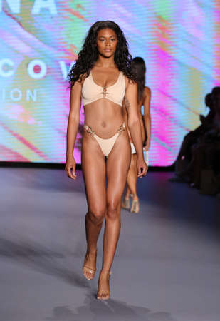 MIAMI BEACH, FLORIDA - JULY 09: A model walks the runway as Oh Polly Launch New Swimwear Brand Neena Swim For Miami Swim Week Paraiso Miami Beach at The Paraiso Tent on July 09, 2021 in Miami Beach, Florida.のeditorial素材