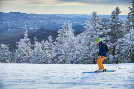 Skier skiing downhill in high mountains on a beautiful winter sunny day. Amazing landscape on the background.の写真素材
