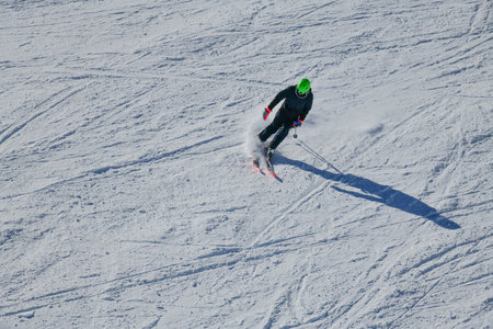 Active winter holidays, skiing downhill on a sunny day. Dynamic picture.