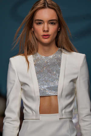 MILAN, ITALY - FEBRUARY 24: A model walks the runway at the Genny fashion show during the Milan...