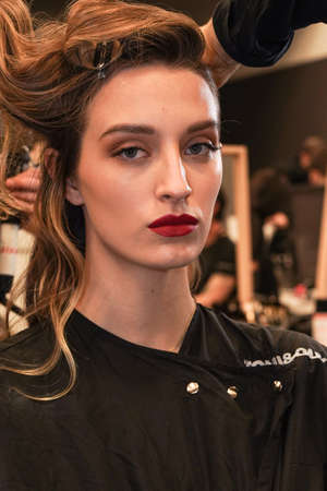MILAN, ITALY - FEBRUARY 25: A model getting ready backstage before  the Elisabetta Franchi fashion...