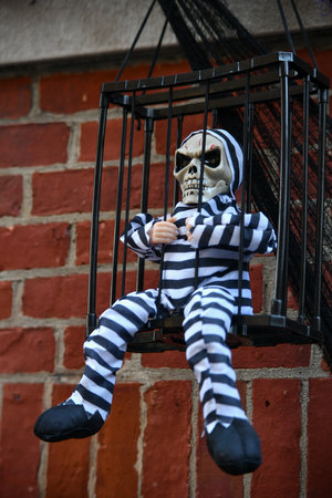 Spooky scary decorations during halloween outside the house. Skeleton and pumpkins.の写真素材