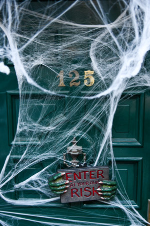 Door decorated with web for Halloween.