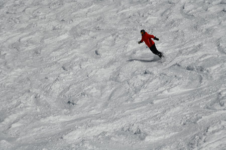 Snowboarder running down the slope in Vail Mountain Resort. Winter sport and recreation, leisure outdoor activities.の写真素材