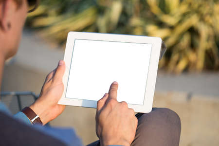 Man with tablet in hands at park