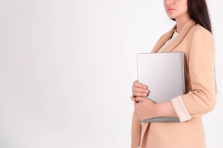 Successful business woman on grey background with copy space laptop mock up, blankの写真素材