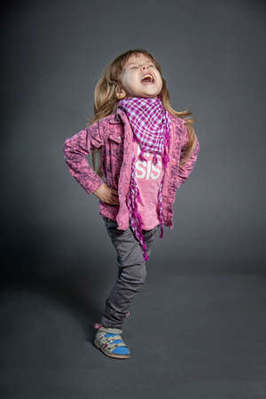 The little girl laughs very hard and smiles. Children 's laughter and joyのeditorial素材