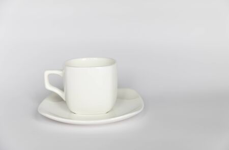 Empty white cup on saucer on isolated white backgroundの写真素材