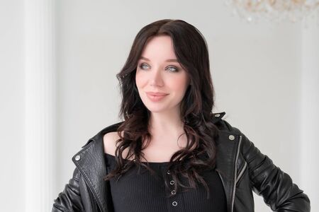 A large portrait of a beautiful white young brunette girl against a white background