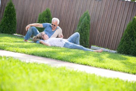 beautiful adult couple. portrait of happy of middle aged couple on a green grassの写真素材