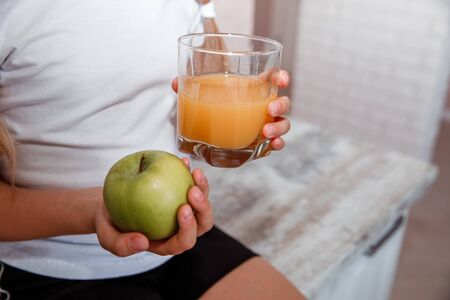 keeps an apple and a glass of juiceの写真素材