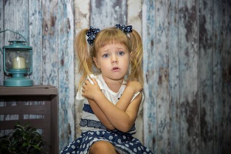 Little girl being very tired and sleepy and rubbing her eyes