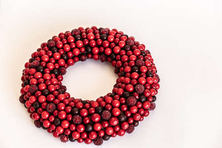 Christmas wreath on white background. red wreath circle of berries. Copy Spaceの写真素材