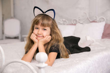 Copy space. Little beautiful girl with cat earsの写真素材