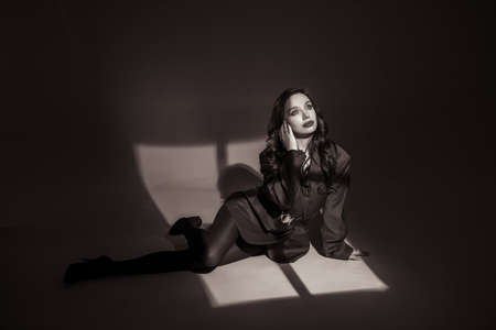 Beautiful lady in the spotlight. Fashion art photo.の写真素材