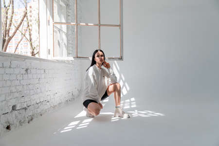 fashionable girl in sweatwear posing to the camera. full length photo. fashion, sporty styleの写真素材