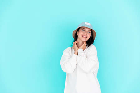 Fashion girl in blank sweatshirt jacket hoody in summer hats on a blue background. Copy spaceの写真素材