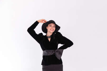 Young girl female model brunette in black hat on white background. Copy spaceの写真素材