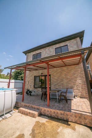 Swimming pool under construction, replacing interlocking pavement in rural country house. a large two-story house with a high pool. frame poolの写真素材