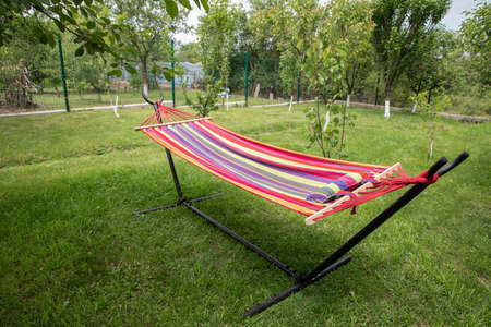 empty hammock in a green garden. the concept of summerの写真素材
