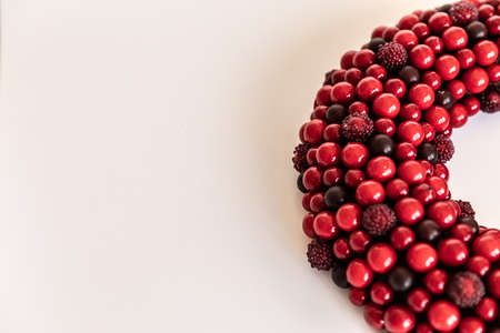 Christmas wreath on white background. red wreath circle of berries. Copy Space