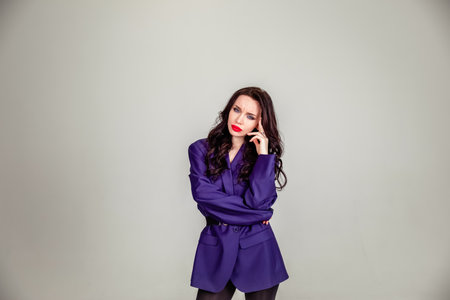 beautiful young Russian model girl in retro clothes, she is dressed in a large male purple jacket. the concept of retro clothing. clothing for all sizesの写真素材