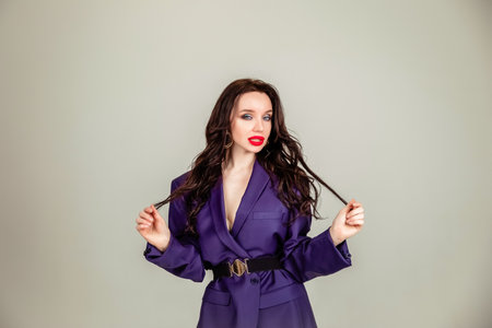 beautiful young model girl in retro clothes, she is dressed in a large male purple jacket. the concept of retro clothing. clothing for all sizesの写真素材