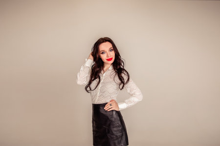 young woman closeup portrait. beautiful brunette girl with red lips on isolated over gray background. Copy spaceの写真素材