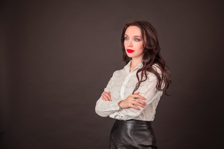 young student businesswoman in a white blouse on a black background. the concept of education finance business. Copy spaceの写真素材