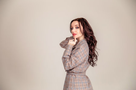 Female model. portrait of a beautiful young brunette with long hair. businesswoman isolated over gray background. Copy spaceの写真素材