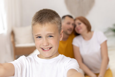 Close up boy takes selfies with his parents. baby, mom and dad