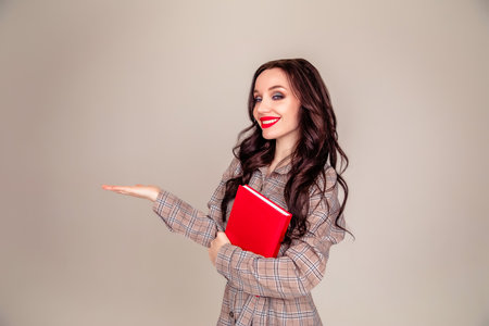 Young happy business woman holding her hand palm up. student. the concept of education. Copy spaceの写真素材
