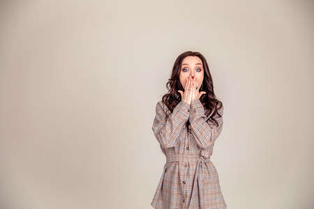 Portrait of happy surprised girl isolated over gray background. Copy space.の写真素材