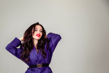 beautiful young Russian model girl in retro clothes, she is dressed in a large male purple jacket. the concept of retro clothing. clothing for all sizesの写真素材