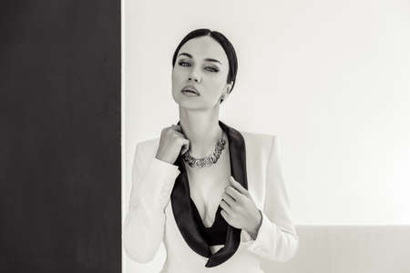 sexy businesswoman in a suit in a white photo studio.の写真素材