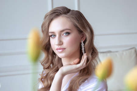 portrait of a beautiful young girl yellow tulips. good morning. springの写真素材