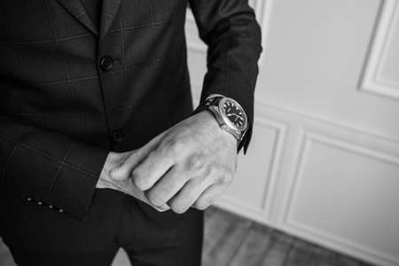 a man looks at his watchの写真素材