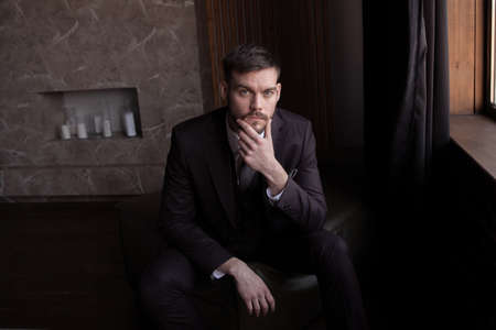 portrait of a brutal young man with a beard. business. successの写真素材