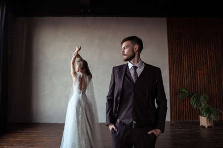 young groom and bride. stylish pair in a beautiful loft interiorの写真素材