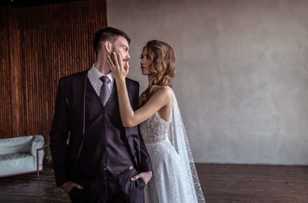 young groom and bride. stylish pair in a beautiful loft interiorの写真素材