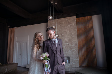 beautiful young couple. groom and bride. a modern wedding. dark interior.の写真素材