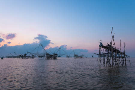Silhouette the big fish net trap at dawn under romance sky.の写真素材