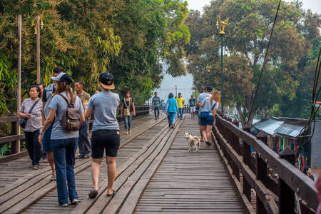 SAGKLABURI THAILAND- MARCH 10 : Unidentified tourists are walking cross the longest wood bridge of Thailand on March 10, 2016 at Mon Bridge.のeditorial素材
