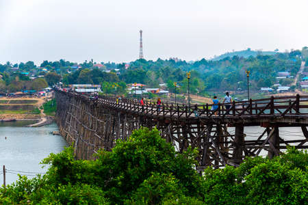 SAGKLABURI THAILAND- MARCH 10 : Unidentified tourists are walking cross the longest wood bridge of Thailand on March 10, 2016 at Mon Bridge.のeditorial素材