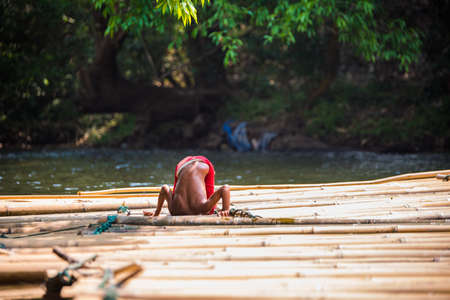 SAGKLABURI THAILAND- MARCH 11 : Unidentified boyl is fishing on the raft on March 11, 2016 at Songkhalia Creek.のeditorial素材